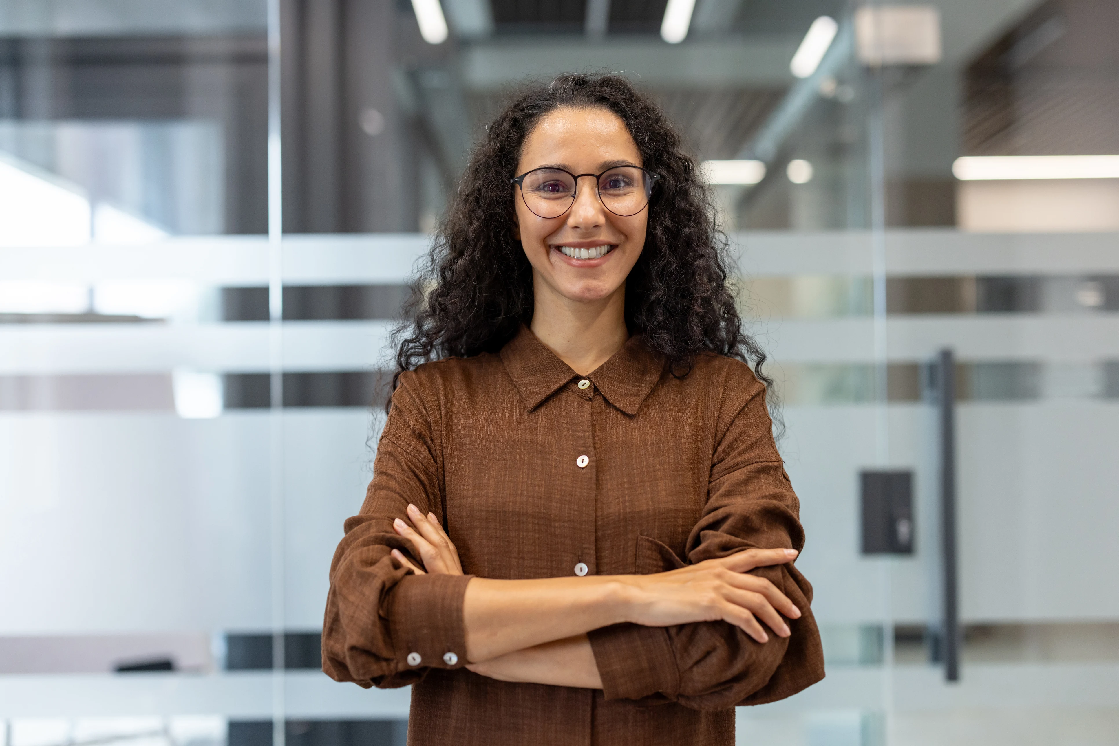 Smiling woman in a brown shirt in a modern office